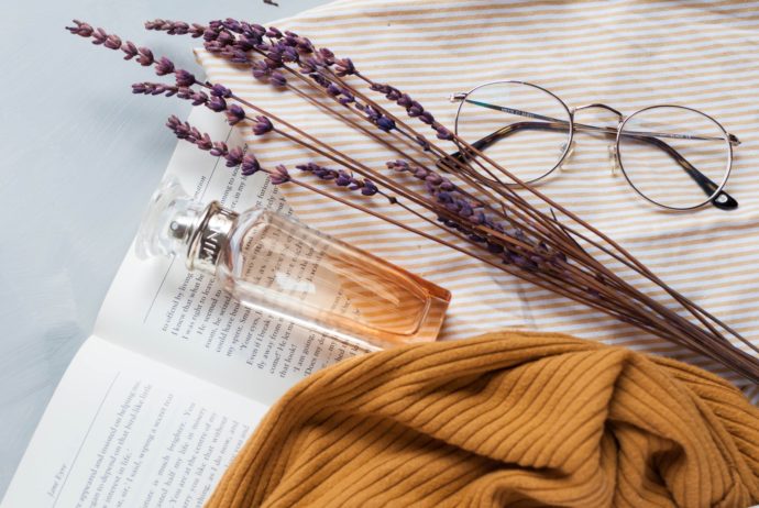 fragrance bottle, lavender, and eyeglasses